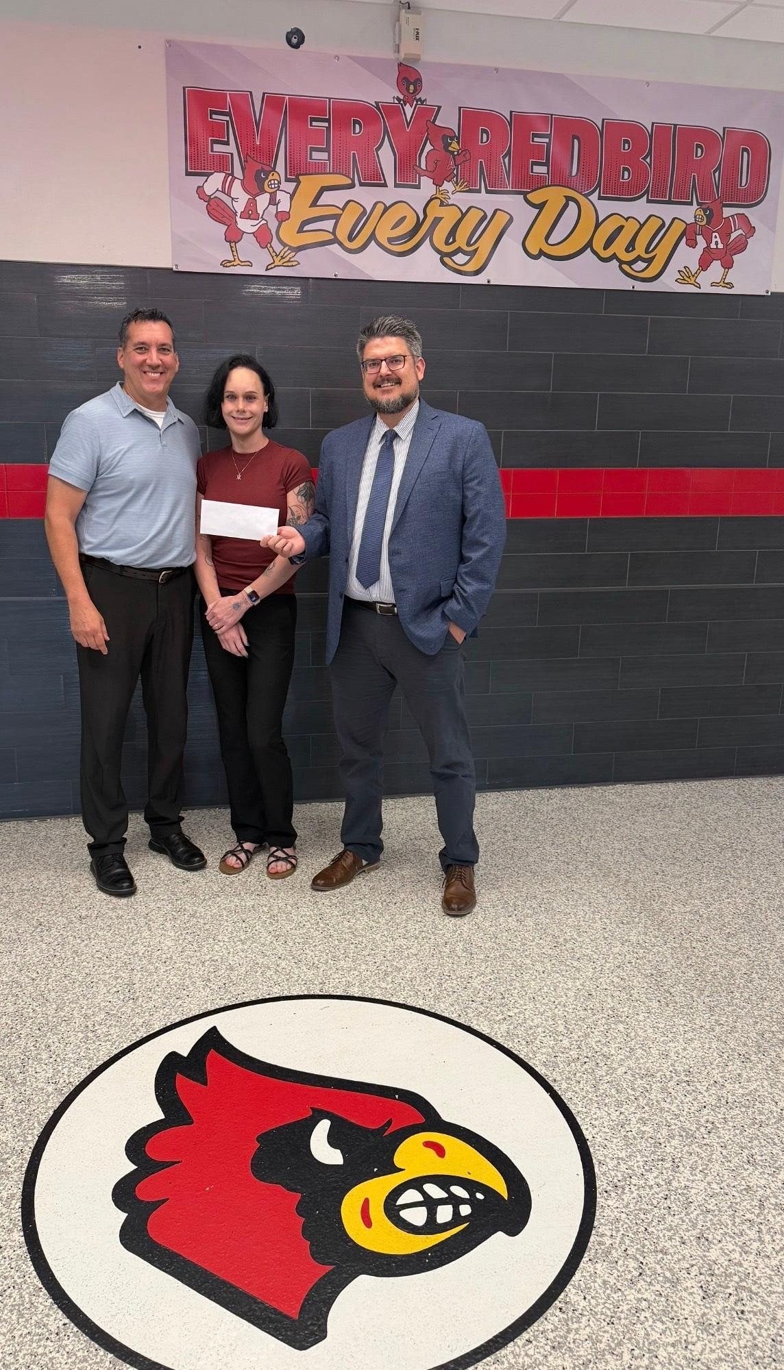Liberty Bank Market President, Jared Siebert (right), presents a check to Principal Brian Saenz (left) and Teacher Ariya Barrington (middle) to sponsor equipment for Alton Middle School’s newest class – Medical Detectives. The class launches this week and will allow students, during their unified arts period, to play the role of real-life biomedical scientists and investigators to solve simulated health mysteries and diseases.
