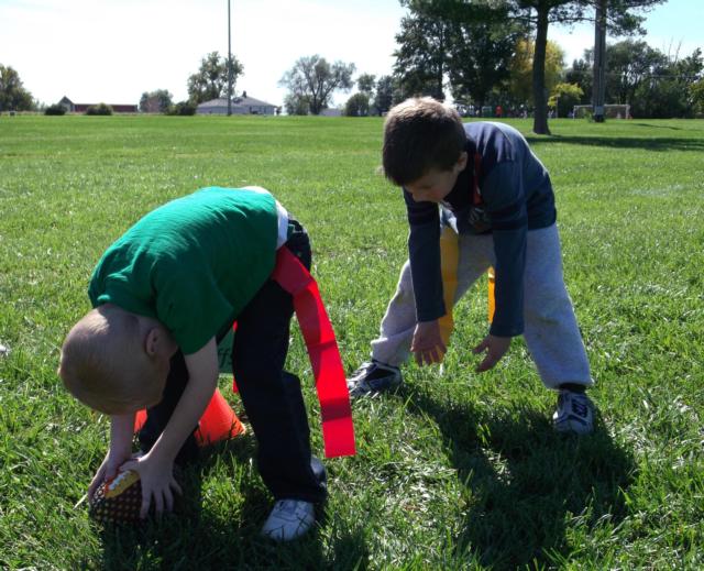 Two youngsters work on their technique at the “hiking & hand-off” station.