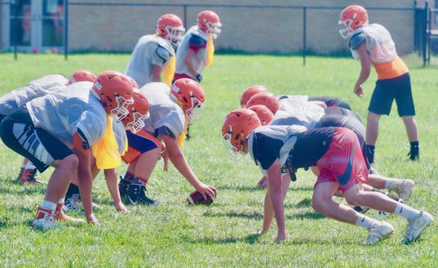 The offensive line and defensive line take their positions for a play.