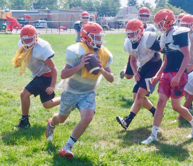 Greenfield-Northwestern quarterback Zane Thomson looks for a receiver in practice at Greenfield Elementary.