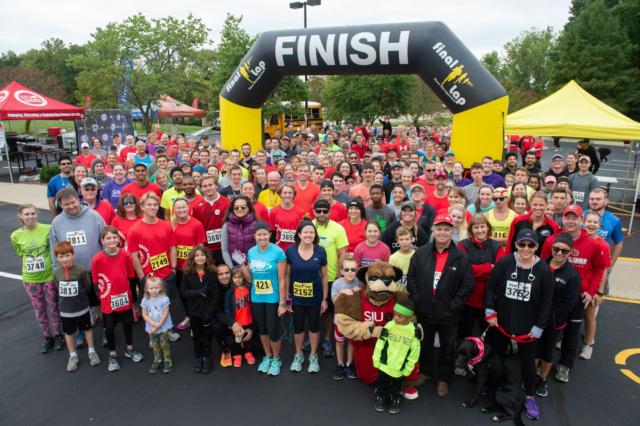 Runners take their places at the starting line alongside SIUE’s Eddie the Cougar during the 2nd annual Cougars Unleashed Homecoming Run.