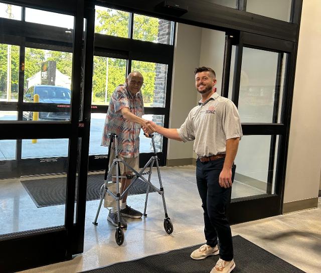 Owner Patrick Schutzbach welcomes Mayor Mike McCormick to the store.