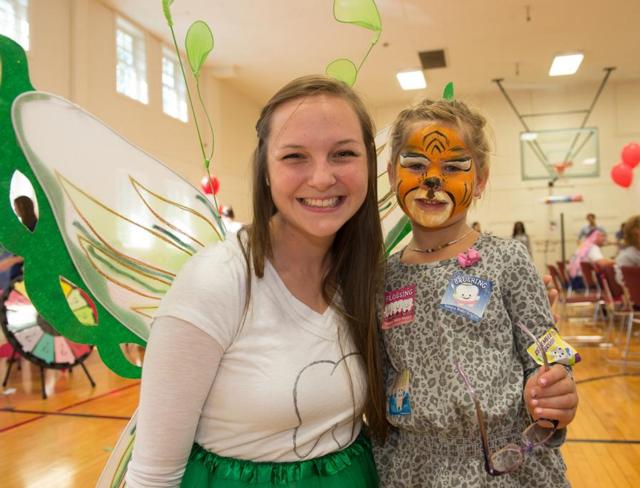 The tooth fairy entertains a young patient at the annual SIU School of Dental Medicine’s Give Kids a Smile Day. 