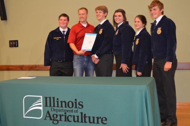 State Representative CD Davidsmeyer (R-Jacksonville) and students from the Pittsfield FFA pose for a portrait after the ceremonial signing of HB470.