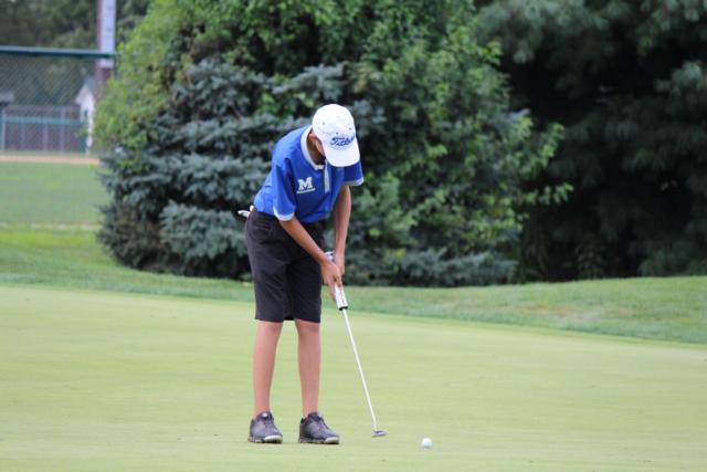 Marquette Catholic High School athlete putting during the Alton Tee Off Classic. 
