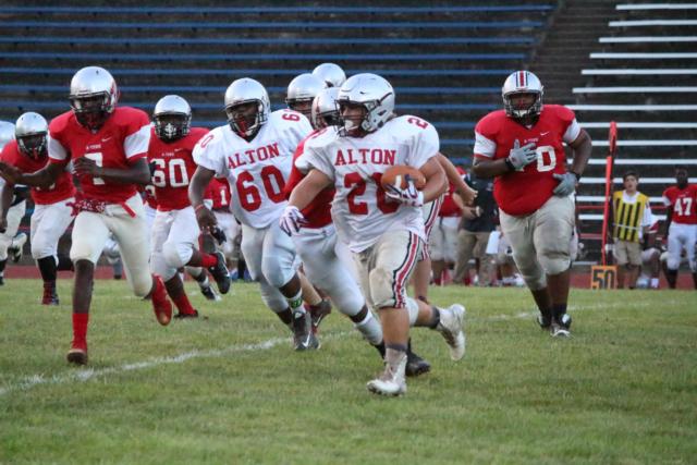 Freshman Bobby Smith Jr. makes his way down the field while avoiding the red squad in the scrimmage. 