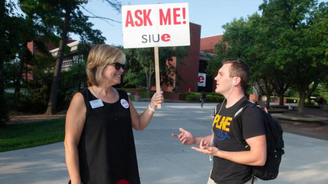 Meg Werthin with the Office of Registrar greets freshman Jared Liley, of East Alton, on the first day of classes.