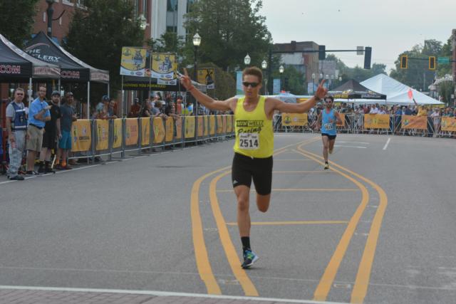 Luke Padesky crosses in the finish line in the Downtown Dash in first place. (Photos by Dan Brannan)