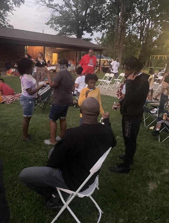 Parents and kids wait for the movie to start at dusk.