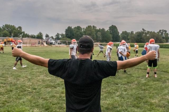 A coach provides a signal during a recent Greenfield-Northwestern practice. (Photo courtesy of Micheal Weaver)