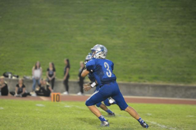 Marquette Catholic quarterback Trey Aguirre takes aim at a receiver on Saturday night at Public School Stadium. (Photo by Dan Brannan)