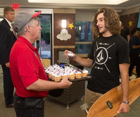 Chancellor Randy Pembrook converses with student Chase Vickery, a psychology major from Taylorville, during the House Calls event.