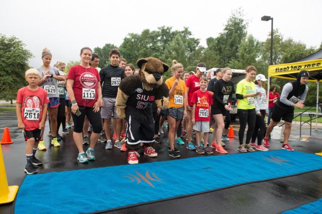 Runners take their places at the starting line alongside SIUE’s Eddie the Cougar during the inaugural Cougars Unleashed Homecoming Run.