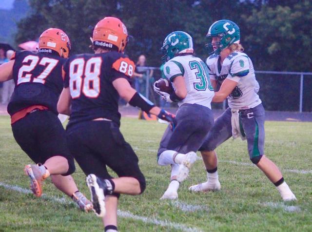 Carrollton quarterback Hunter Flowers hands off to Garrett Settles who would be tackled for a 7-yard loss by the Beardstown Tigers defense on Friday night.