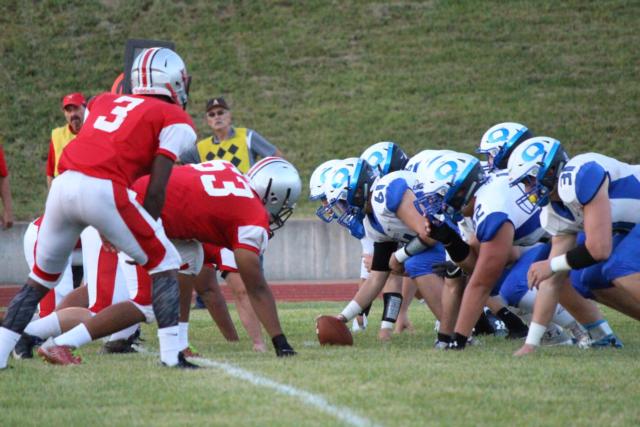 With the ball in Quincy's possession, the two teams prepare for the snap. 