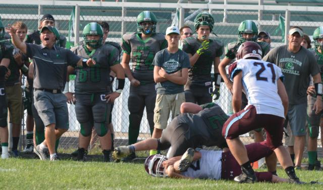 Carrollton coach Nick Flowers attempts to get his team one more play at the end of Carrollton's game with Mendon-Unity, right before the final touchdown pass from Wade Prough to Jerrett Smith. (Photo by Dan Brannan)