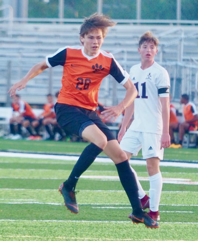 Edwardsville foward A.J. Sullivan strikes a shot into the back of the net in the first half against the Gibault Catholic Hakws in Edwardsville on Wednesday night.