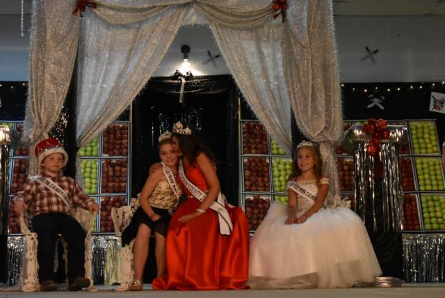 Jr. Miss Calhoun, Neveah Grissom, hugging retiring Miss Calhoun Cassidy Becker as she listens to her final goodbye recording.