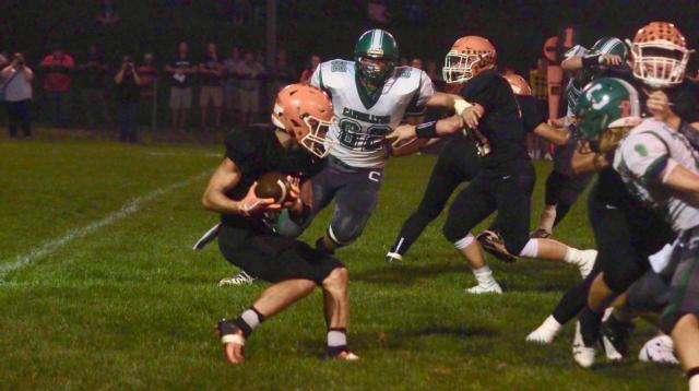 Greenfield-Northwestern sophomore running back Denver Davenport is caught in the backfield by a host of Hawks getting behind the offensive line in Greenfield on Friday night.