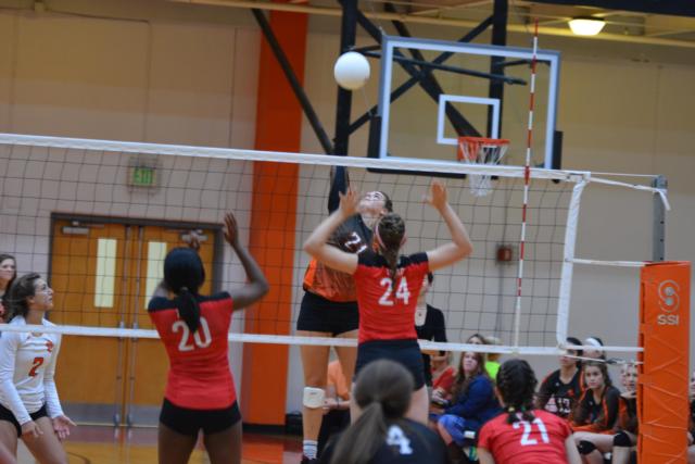 Rachel Pranger, always strong at the net, rips for a kill against Triad.