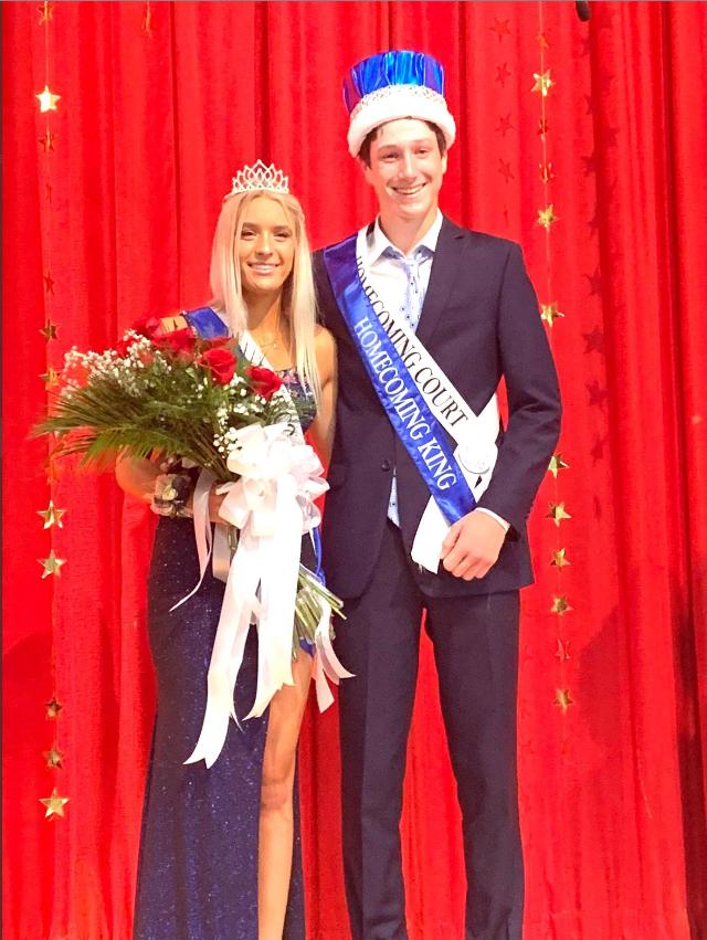 The two pose for a picture together at the dance. 