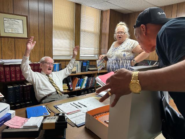 Barbara Burk and others gathered in Ryan's office to celebrate.