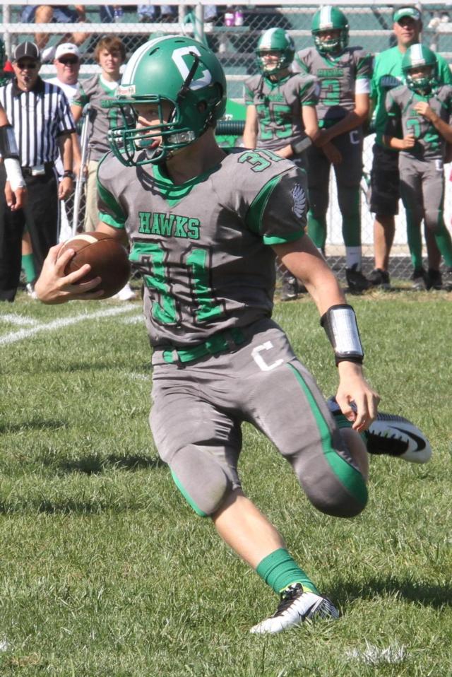  Byron Holmes carries the pigskin for the Hawks and gets some yardage against the Cougars. The Hawks had to reschedule the Friday night game to play on Saturday afternoon due to no lights on Carrollton&rsquo;s football field. (Photo courtesy of Sherry Fraley Photography)