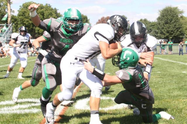 Carrollton’s Jerrett Smith looks like a Hawk with a swooping tackle on West Central’s Kobie Hoover, Smith gets help wrapping up from teammate Nate Shanks. The Cougars bid for the gold football dropped a notch on Saturday with the loss to the Hawks. (Photo courtesy of Sherry Fraley Photography)