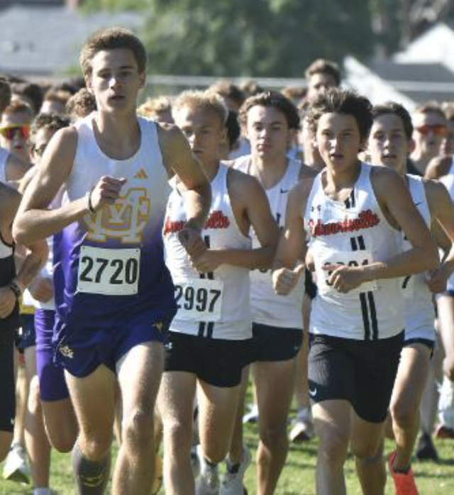 Civic Memorial's Max Weber, flanked by two Edwardsville runners. 