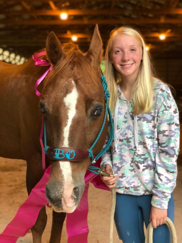Maddie Bash and her favorite horse at Happy Hooves - Bo.