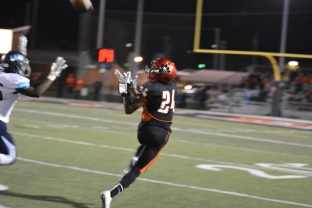 Chrys Colley snares one of his touchdown catches against Belleville East on Friday night. (Photo by Dan Brannan)