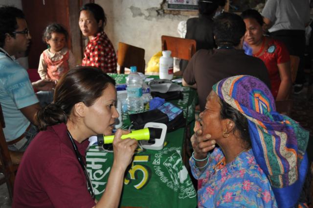 Dr. Puja Gurung examines a patient in one of the temporary medical clinics Team Alpha built. She volunteered in Nepal after the 7.8 magnitude earthquake devastated the country last spring.