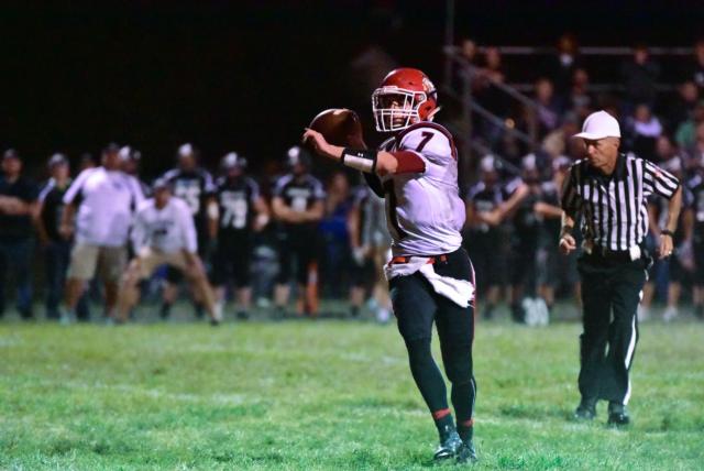Calhoun's Tick Bick takes aim for one of his Warrior receivers. Bick ran for a touchdown and tossed threw TD passes against West Central on Friday night. (Photos by Alison Godar)