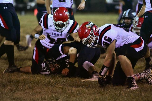 #40, Scout White, and #86, AJ Hillen, tackle a player from West Central.